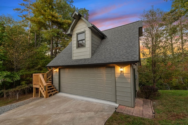 view of garage at dusk