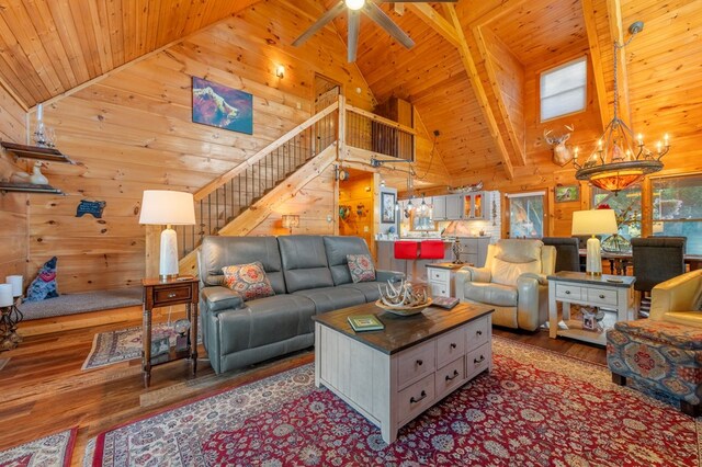 living room featuring wood walls, high vaulted ceiling, and wood ceiling