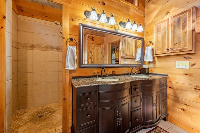 bathroom with vanity, wood walls, and tile patterned flooring