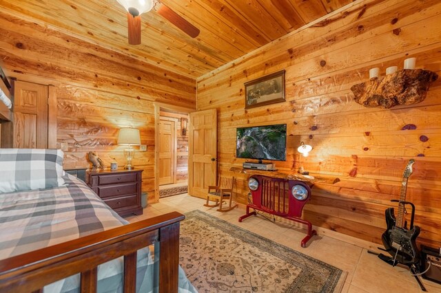 bedroom featuring light tile patterned flooring, wooden walls, and wood ceiling