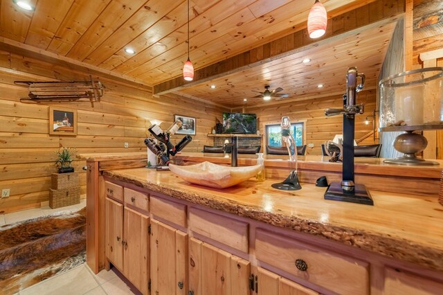 kitchen with decorative light fixtures, butcher block counters, light tile patterned floors, and wood ceiling