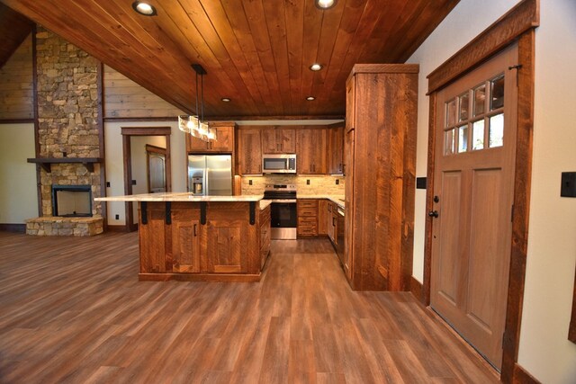 kitchen with wooden ceiling, hanging light fixtures, stainless steel appliances, and dark hardwood / wood-style floors