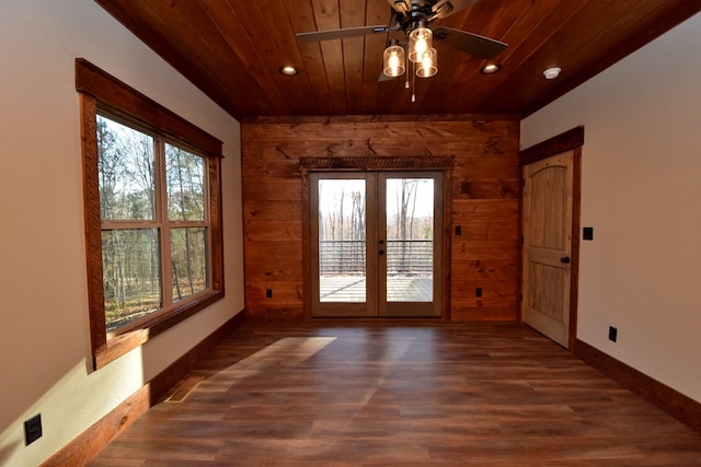 empty room with french doors, dark hardwood / wood-style flooring, a healthy amount of sunlight, and wood ceiling