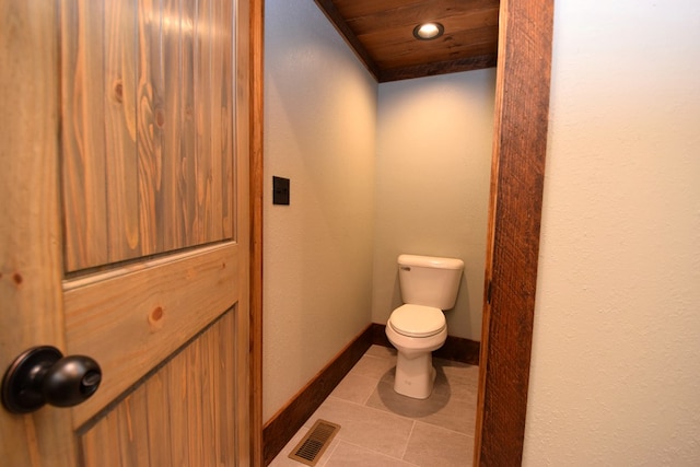 bathroom with tile patterned floors, toilet, and wood ceiling