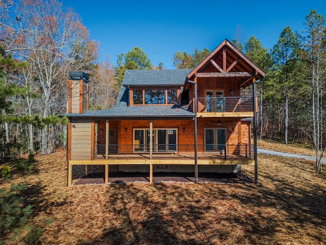 back of property featuring a balcony