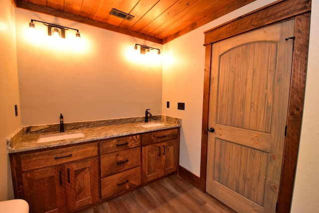 bathroom with vanity, hardwood / wood-style flooring, and wood ceiling