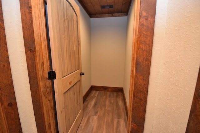 hall featuring hardwood / wood-style floors and wooden ceiling