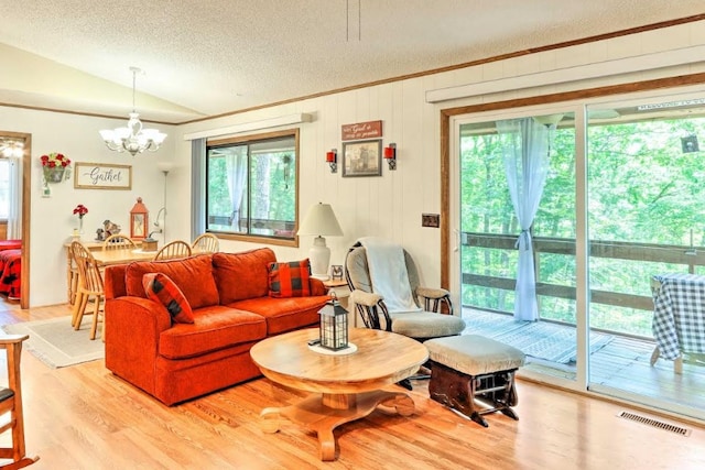 34 Clover Ln, Murphy, NC 28906 - living area with a textured ceiling, plenty of natural light, vaulted ceiling, a chandelier, and light wood-style floors