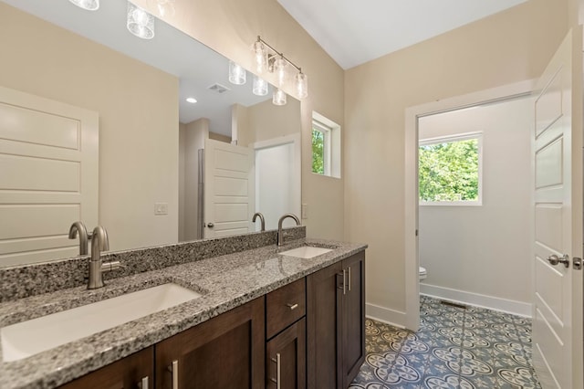 bathroom featuring tile patterned floors, vanity, and toilet