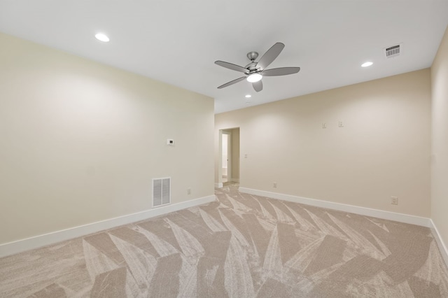 carpeted spare room with ceiling fan