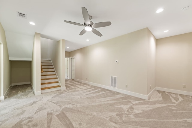 interior space featuring light carpet and ceiling fan