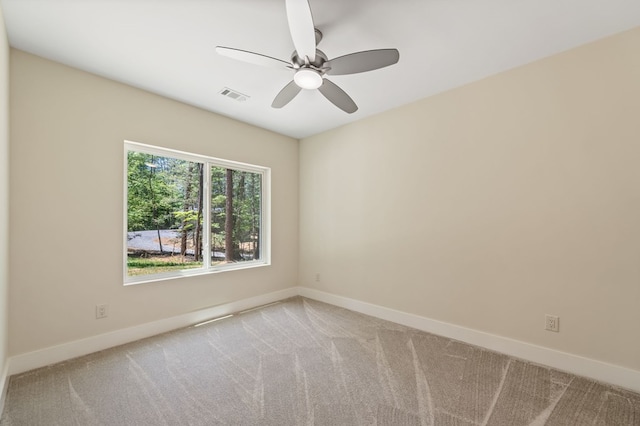 spare room with light carpet and ceiling fan