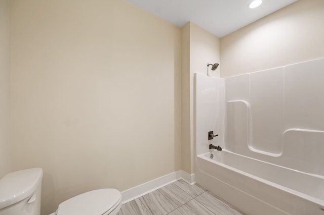 bathroom with toilet and tub / shower combination