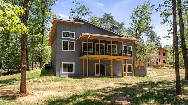 back of house featuring a lawn, central air condition unit, and a deck