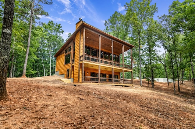 rear view of property with a balcony