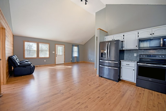 kitchen with white cabinetry, tasteful backsplash, high vaulted ceiling, appliances with stainless steel finishes, and light hardwood / wood-style floors