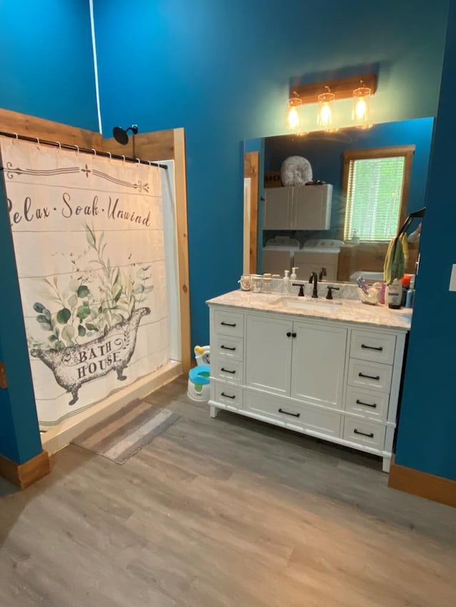 bathroom with hardwood / wood-style floors and vanity