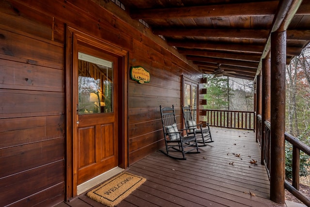 wooden terrace featuring a porch and ceiling fan