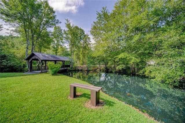 view of community featuring a gazebo, a water view, and a yard