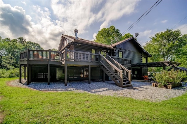 rear view of house with a pergola, a deck, and a lawn