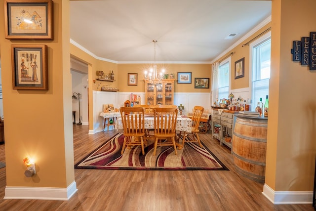 56 Highland Pointe Dr, Ellijay, GA 30536 - dining area featuring a chandelier, wood finished floors, ornamental molding, and wainscoting