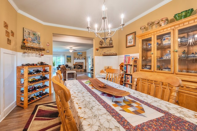 56 Highland Pointe Dr, Ellijay, GA 30536 - dining area featuring ornamental molding, wood finished floors, a chandelier, and a wainscoted wall
