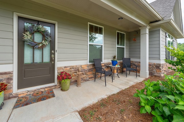 56 Highland Pointe Dr, Ellijay, GA 30536 - view of exterior entry with a porch, stone siding, and roof with shingles