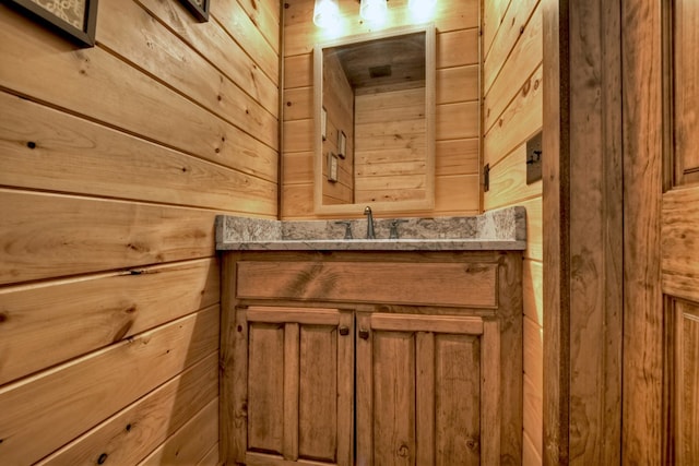 interior space with vanity and wooden walls