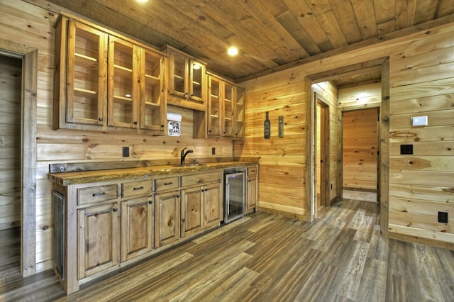 kitchen featuring wooden ceiling, dark wood-type flooring, wine cooler, a sink, and wooden walls