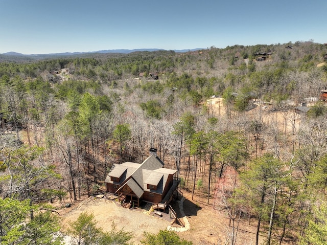 aerial view with a mountain view and a forest view