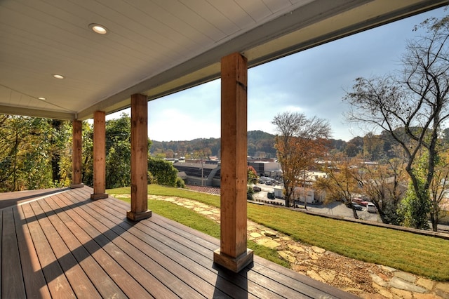 wooden deck with covered porch and a yard