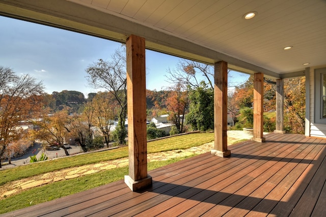 wooden deck with a lawn and a porch