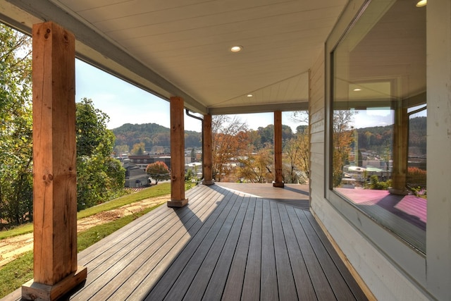 wooden terrace with a mountain view and a porch