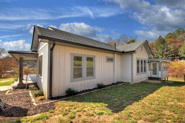 view of side of property with a lawn