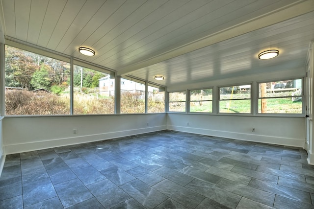 unfurnished sunroom featuring wood ceiling