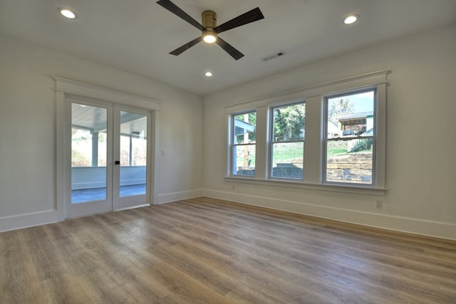 unfurnished room with ceiling fan, wood-type flooring, and french doors