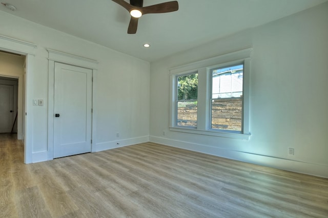 unfurnished bedroom with ceiling fan and light hardwood / wood-style floors