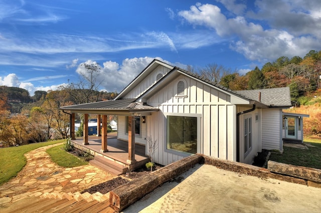 back of property with covered porch