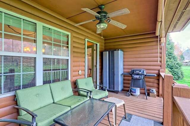 deck with an outdoor living space, a grill, and ceiling fan