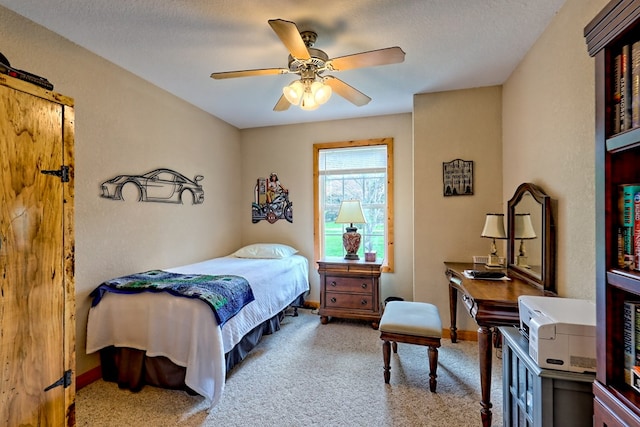carpeted bedroom featuring baseboards and a ceiling fan