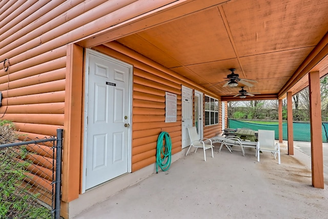 view of patio with ceiling fan and fence