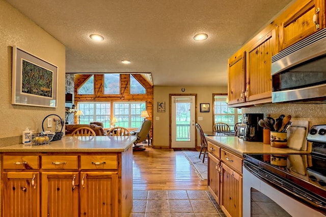 kitchen featuring light countertops, a textured ceiling, and stainless steel appliances