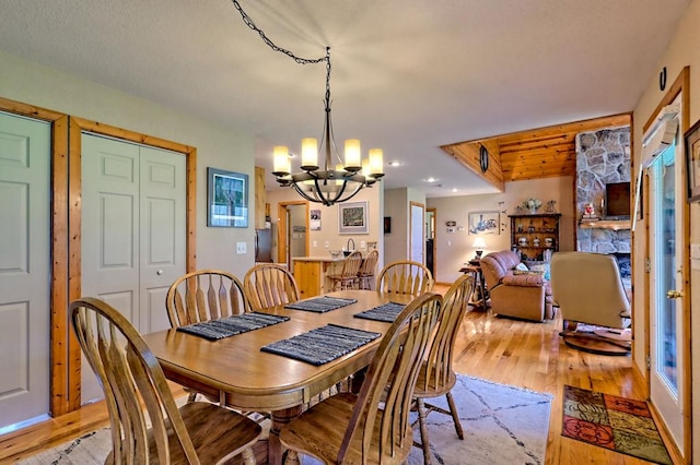 dining space with a chandelier, recessed lighting, and light wood finished floors