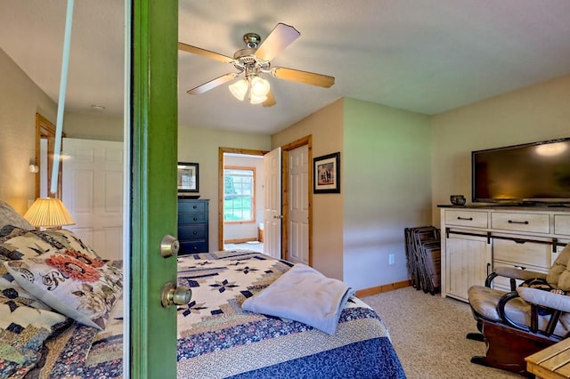 carpeted bedroom featuring baseboards and a ceiling fan