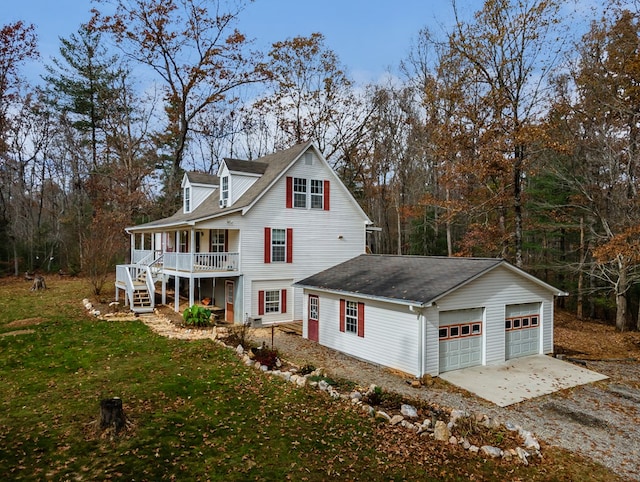 view of side of home featuring a lawn, a porch, and a garage