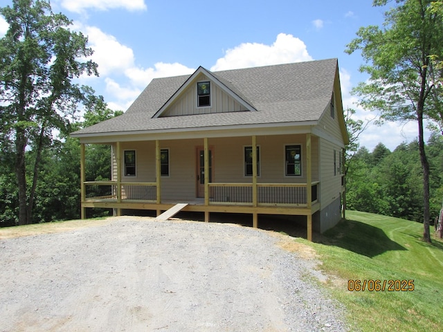 12 Shelton Springs S/D, Hayesville, NC 28904 - view of front facade with a shingled roof, board and batten siding, a porch, and a front lawn