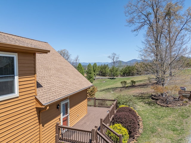 view of yard featuring a deck with mountain view