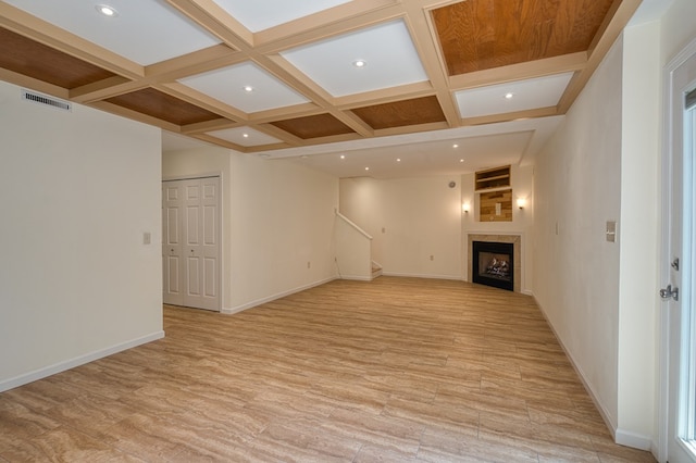 interior space featuring visible vents, baseboards, beam ceiling, light wood finished floors, and coffered ceiling