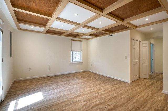 unfurnished room featuring light wood finished floors, baseboards, and coffered ceiling