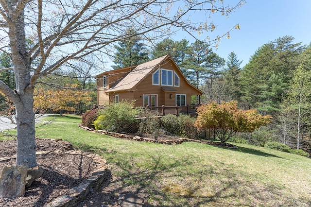 exterior space featuring a yard and a wooden deck